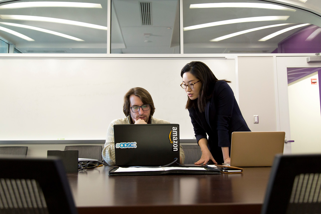 Two people looking at computer