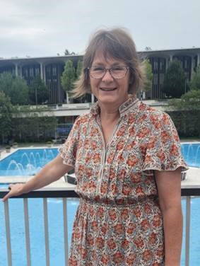 Mary Jo Daly stands overlooking the fountain on the University at Albany campus