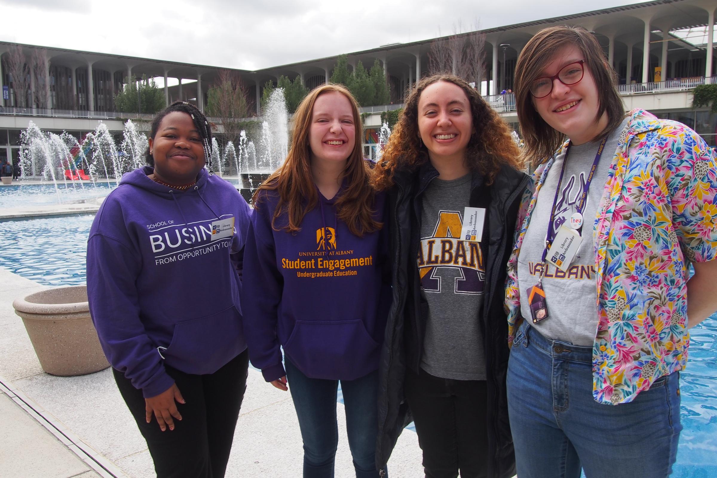 Four Library Ambassadors standing in front of the UAlbany fountain