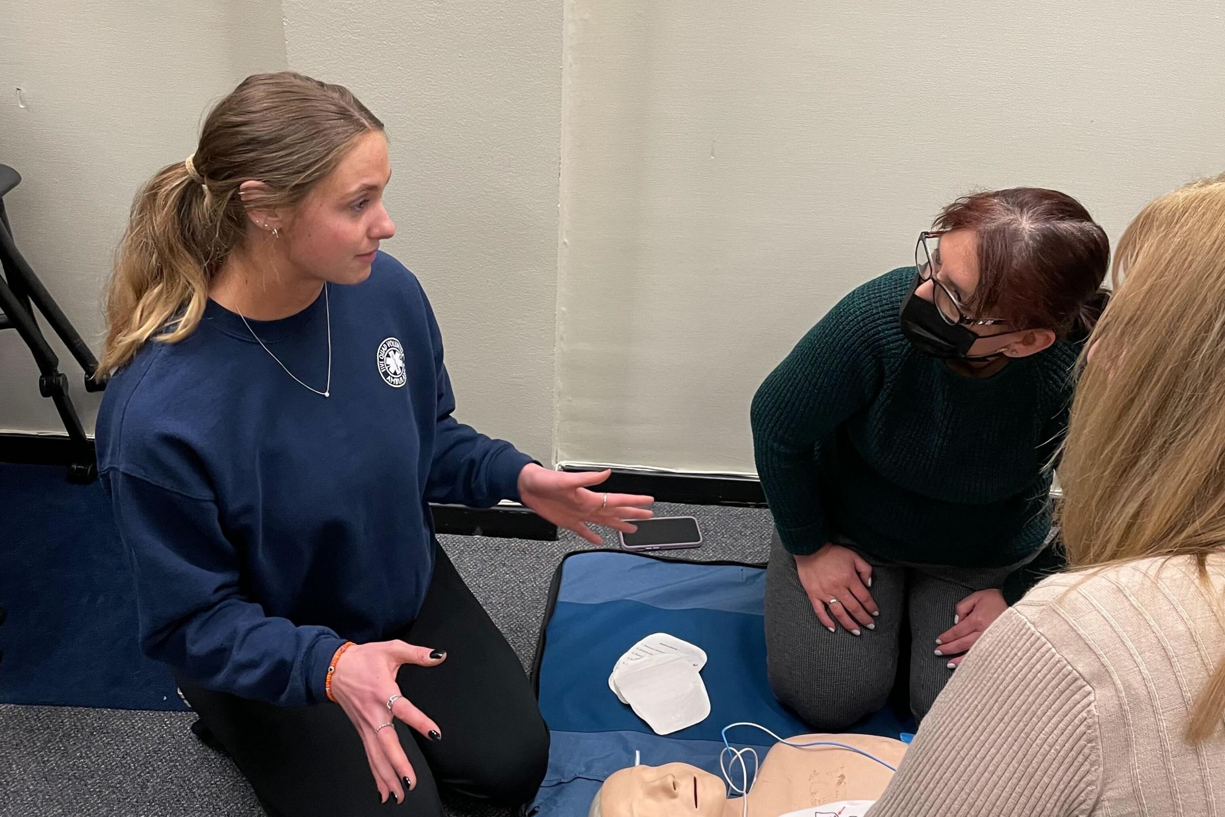 Library staff debrief with Five Quad after an AED demonstration